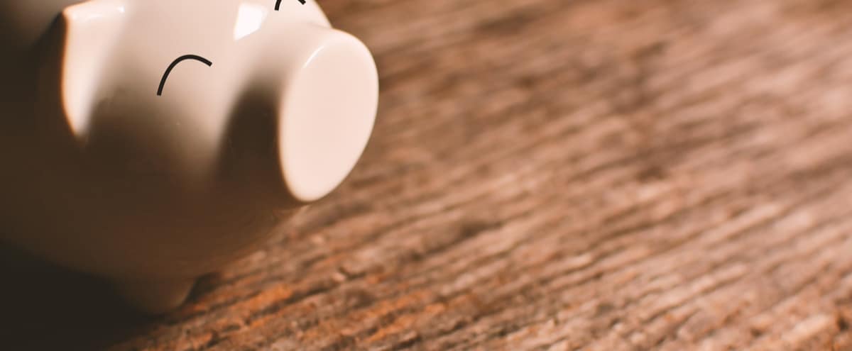 Pink piggy bank on a wooden table