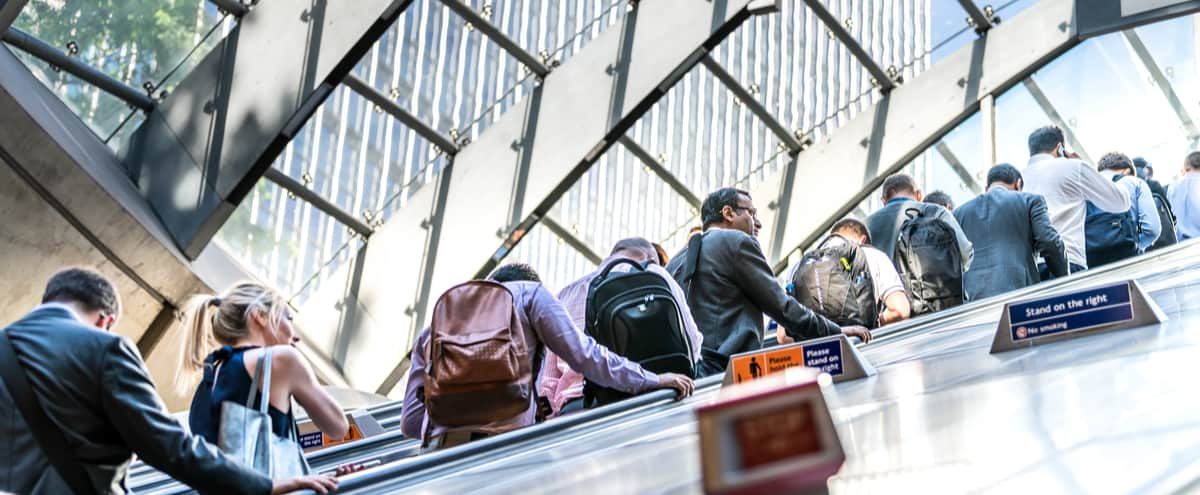 Commuters riding an escalator on the London Underground.
