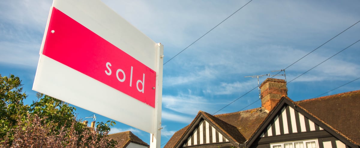 A “sold” sign outside of a home.