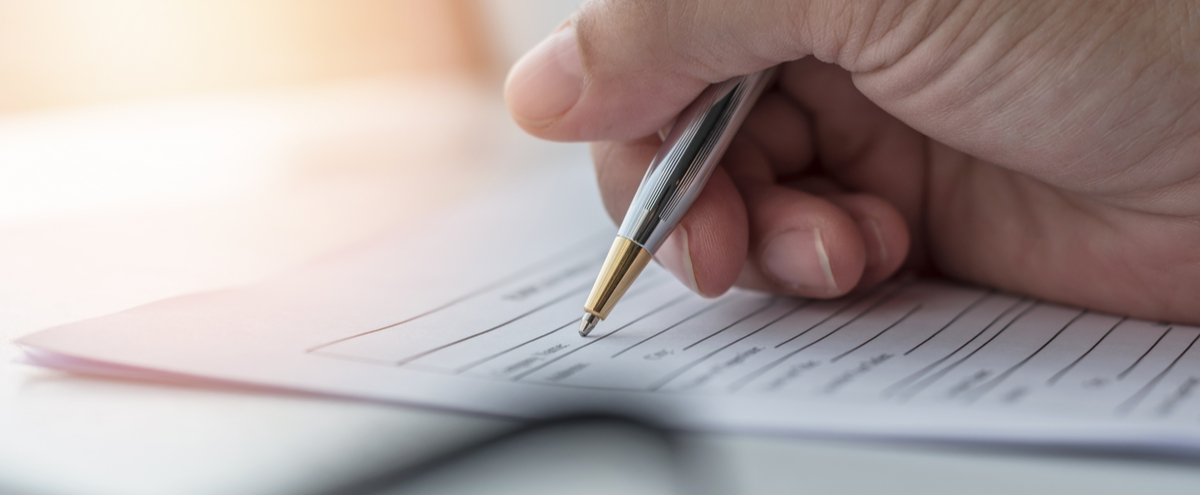 A person filling in paperwork.