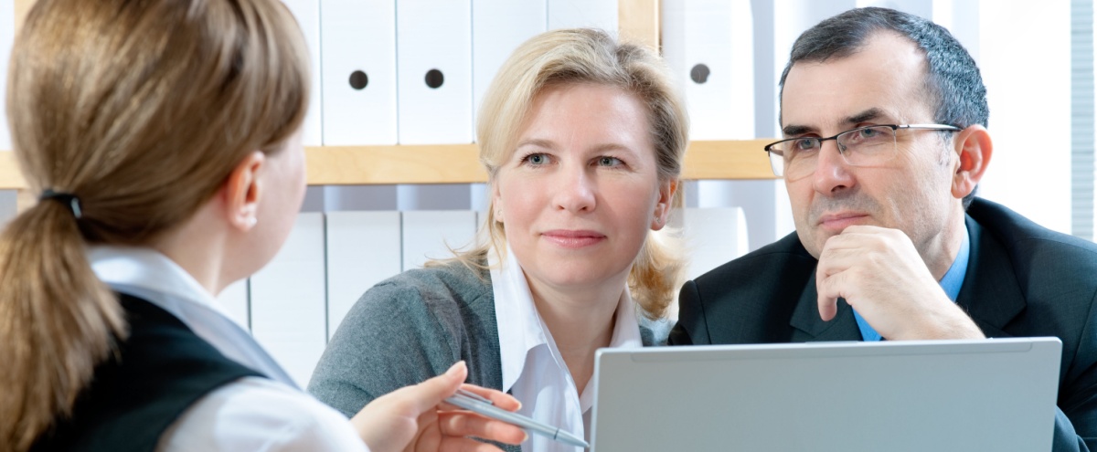 A couple talking to a financial planner.