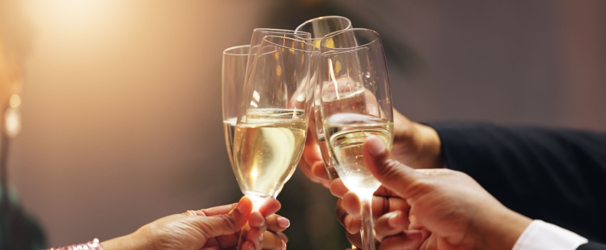 A group of people clinking champagne glasses.