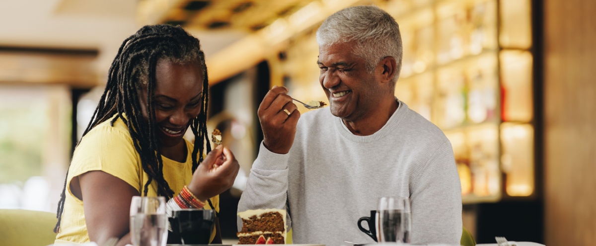 A couple laughing together at a café.