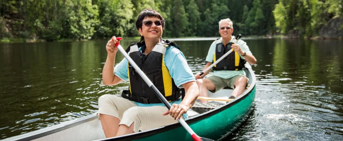 A couple on holiday taking a canoe ride.