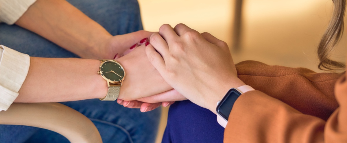 Two people clasping hands.