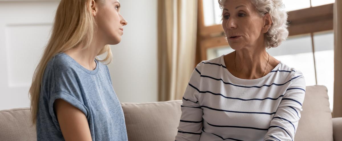 A mother and adult daughter talking.
