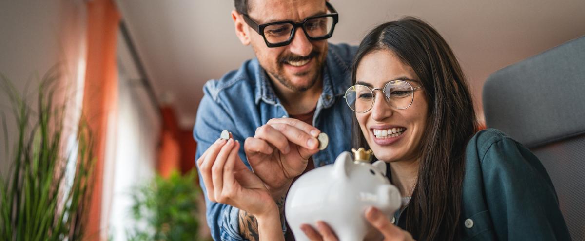 A couple saving in a piggy bank.