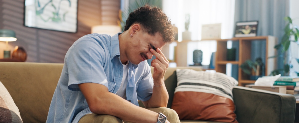 A stressed man with his head in its hand.