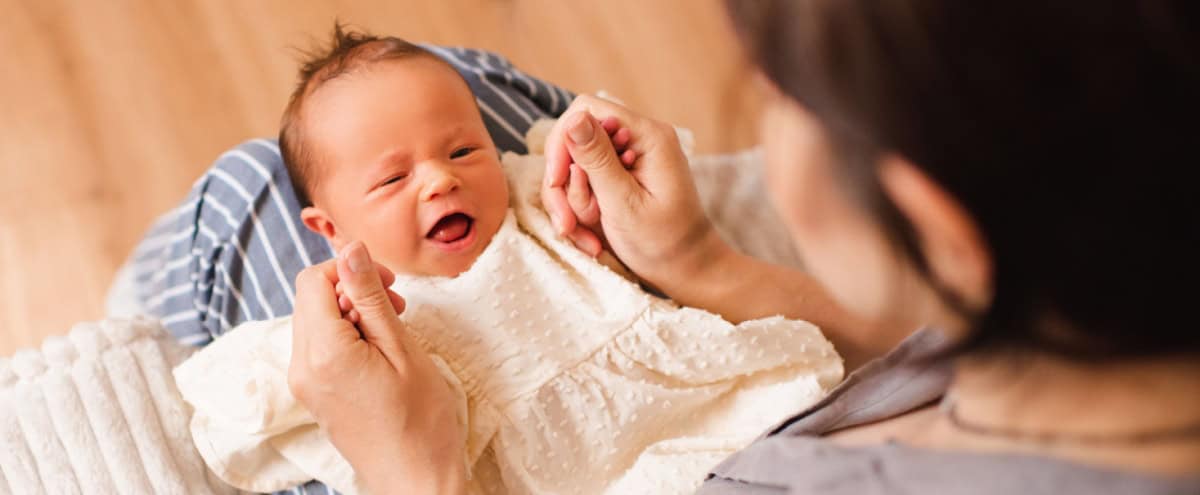 A mother holding a baby.