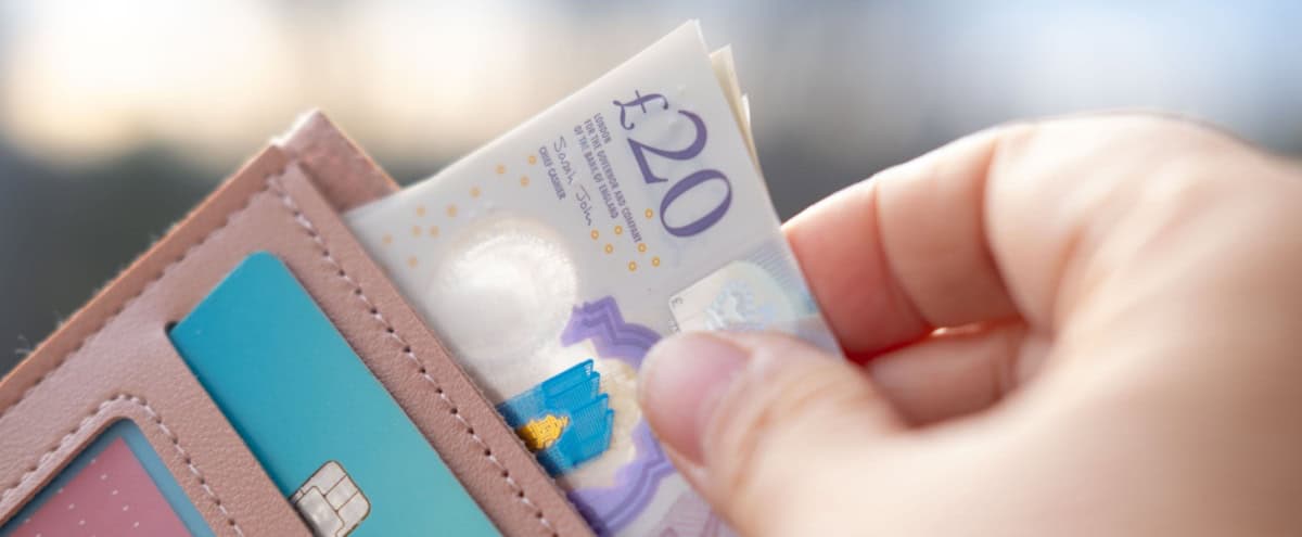 Someone taking money out of a wallet.